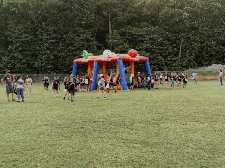 6 in 1 sports interactive inflatable game set up on a school field for field day in Chesapeake VA